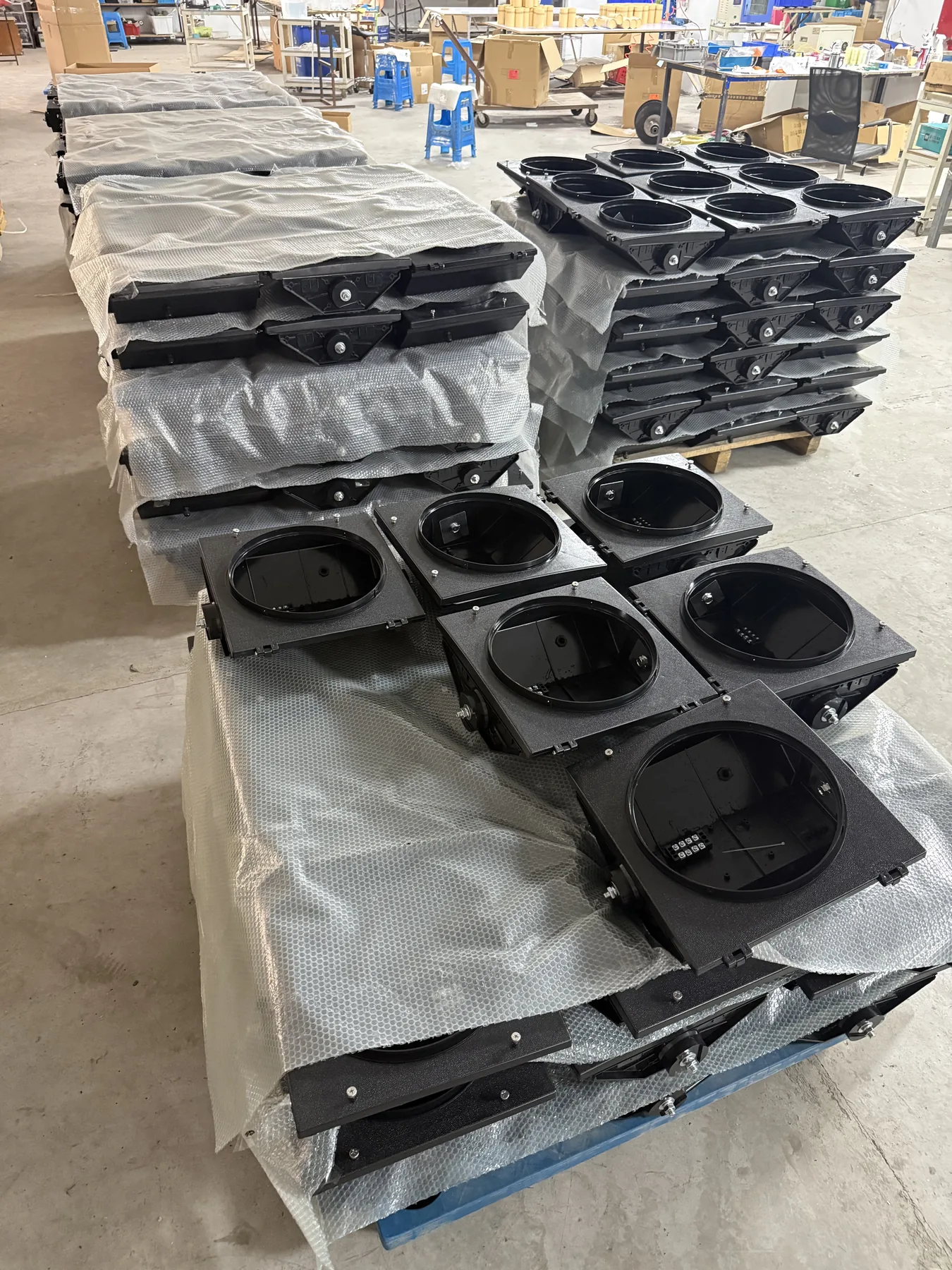Square housings for 300mm LED traffic lights separated with protective material in production